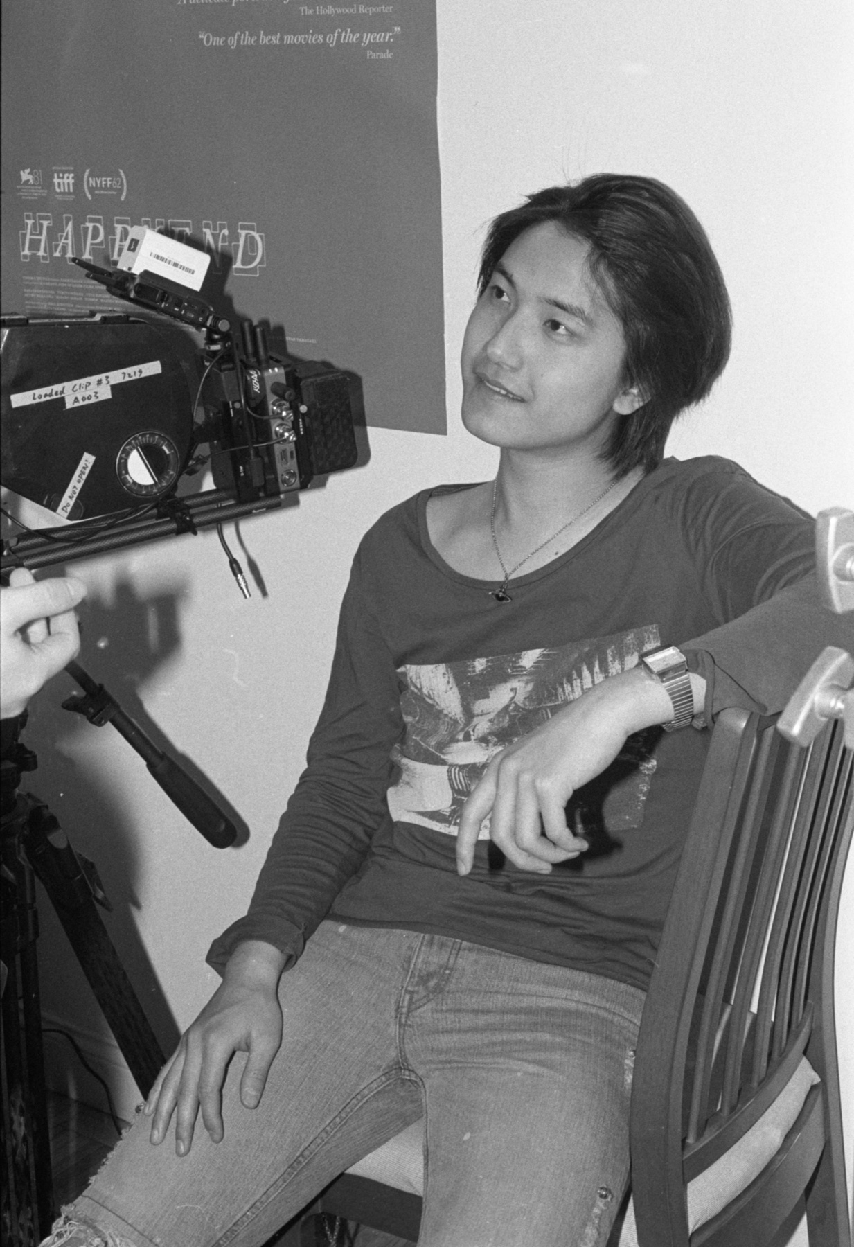 Black-and-white behind-the-scenes photo of Jerry Pan beside a cinema camera