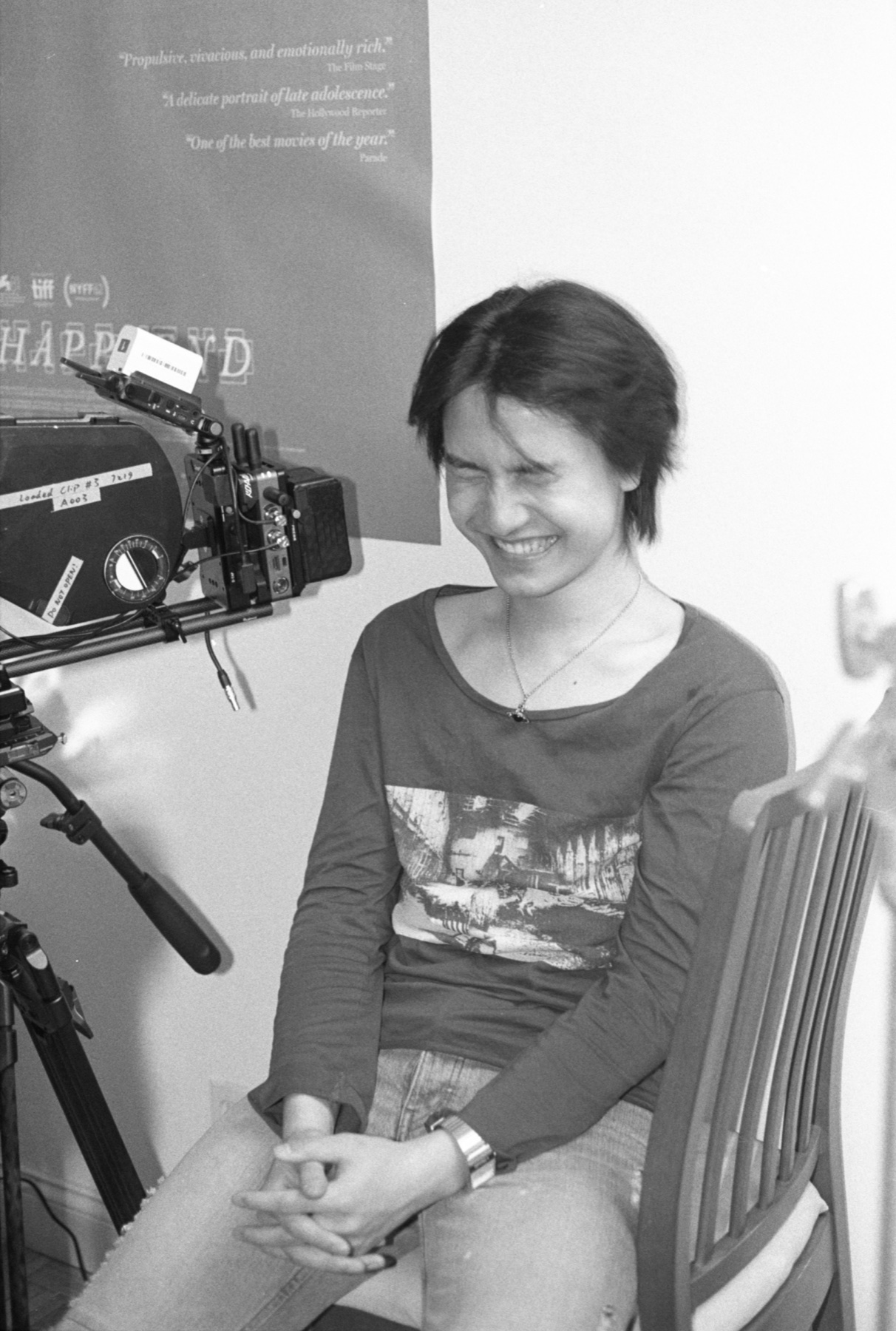 Black-and-white behind-the-scenes photo of Jerry Pan smiling near a camera