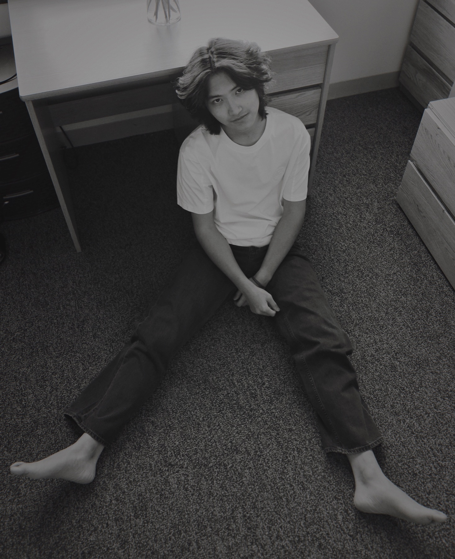 Black-and-white portrait of Jerry Pan holding flowers