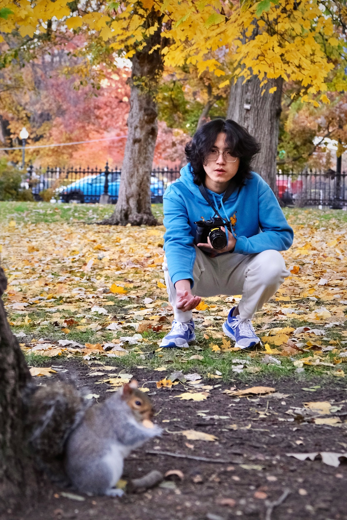 Autumn candid of Jerry Pan crouching with a camera