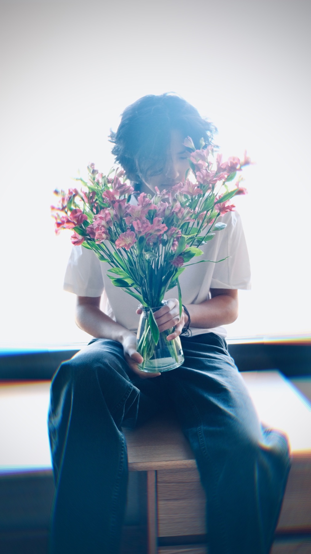 Soft portrait of Jerry Pan holding flowers