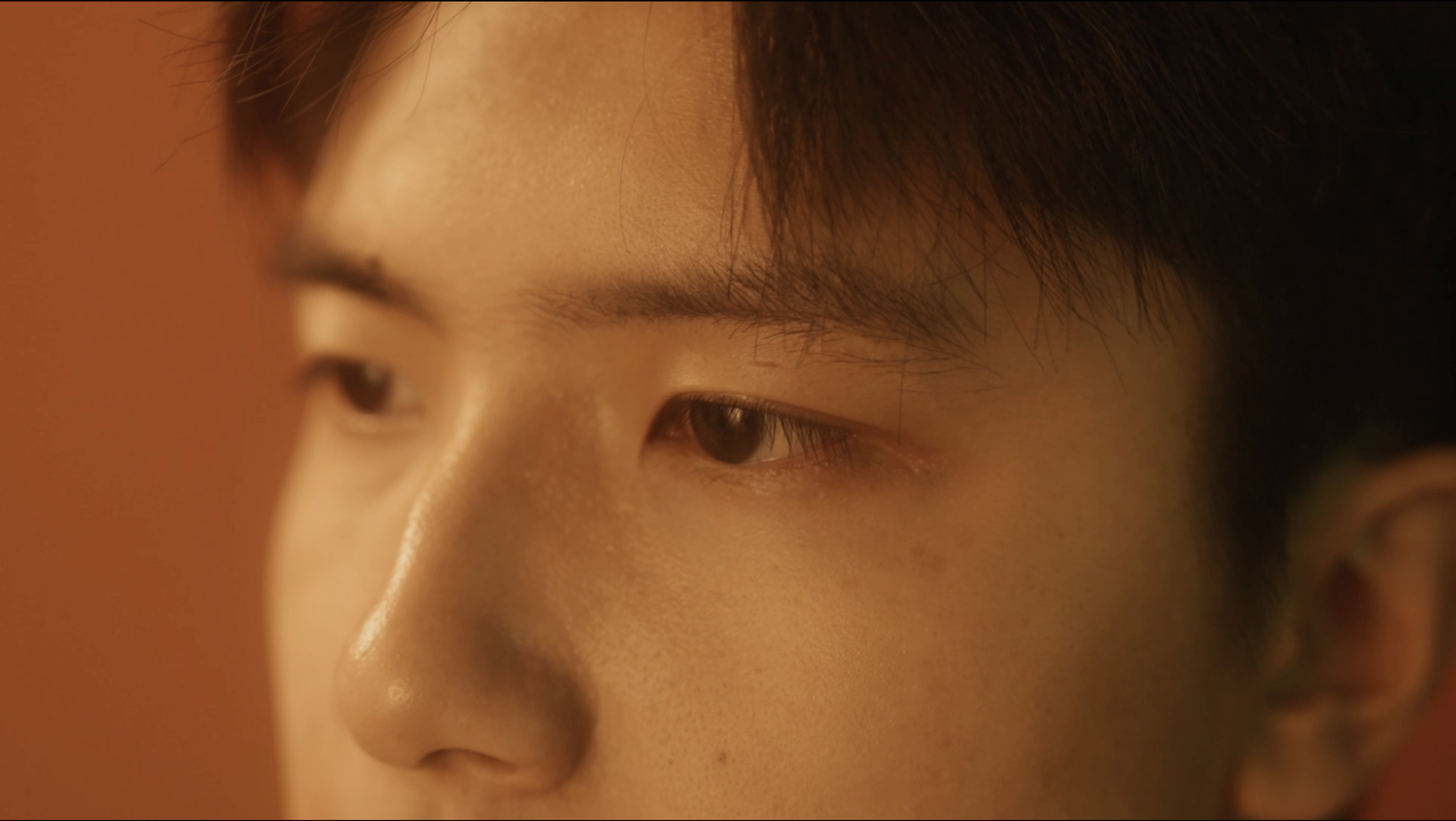 Extreme close-up Inner Space still of Jerry Pan's eyes in warm light