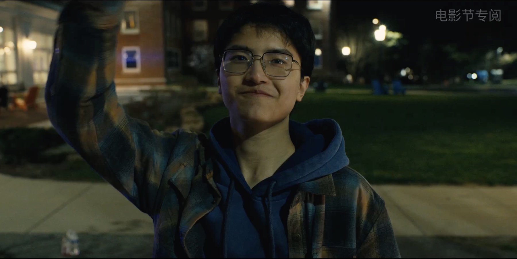 Night exterior still of Jerry Pan smiling