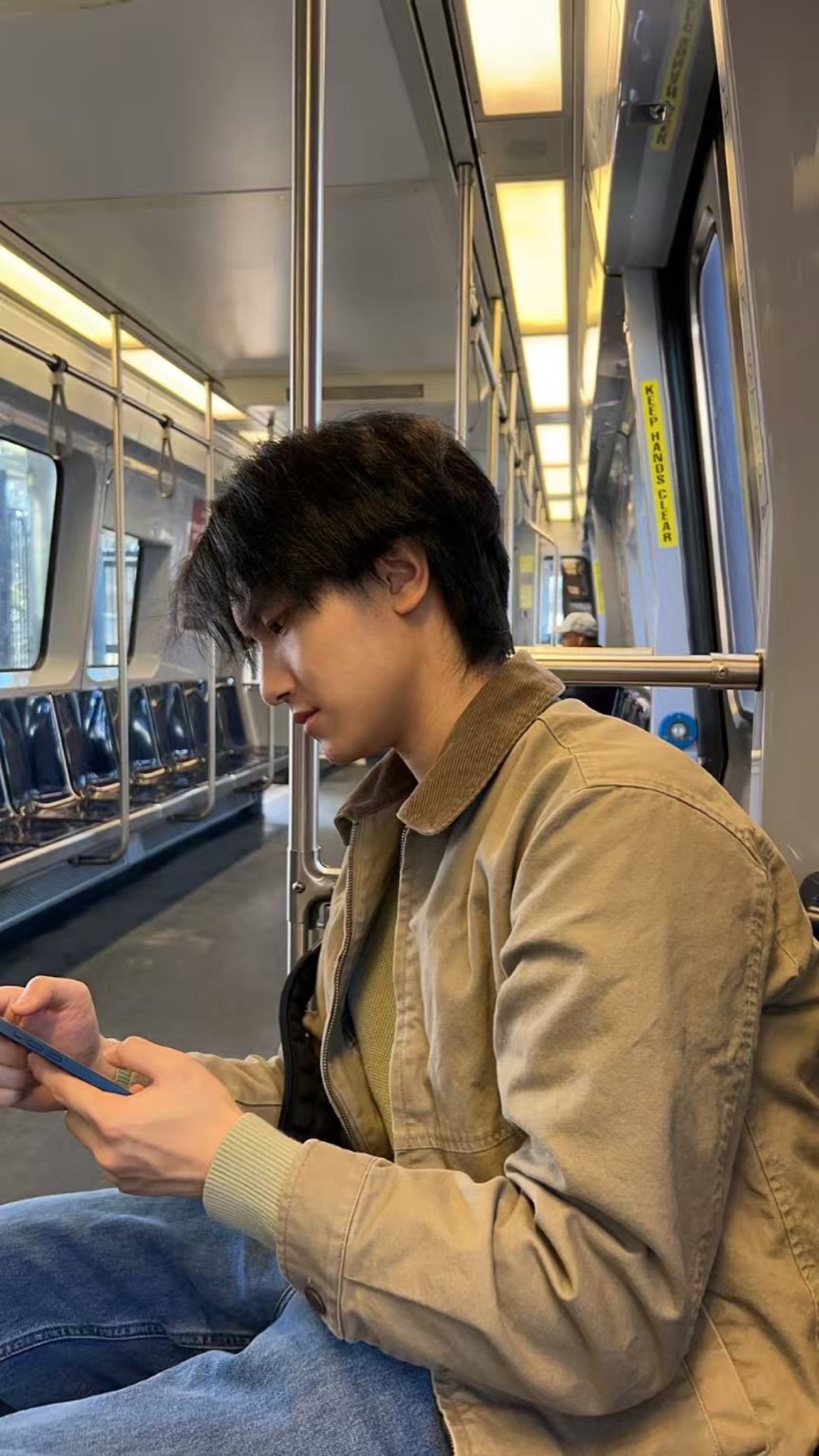 Portrait of Jerry Pan seated on public transit